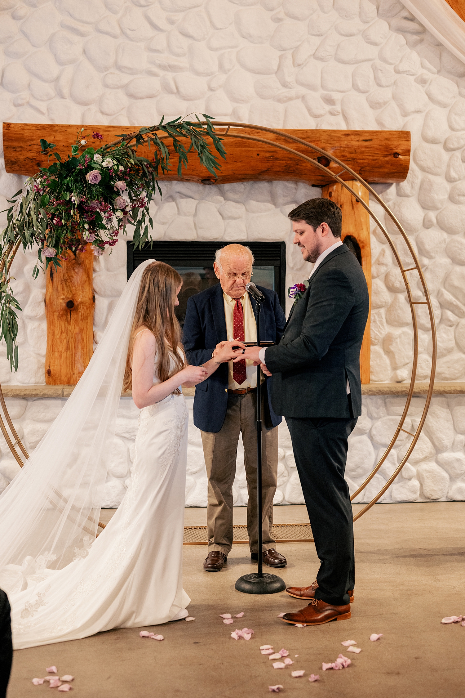 bride and groom exchange vows under circle arch by MN Elopement Photographer