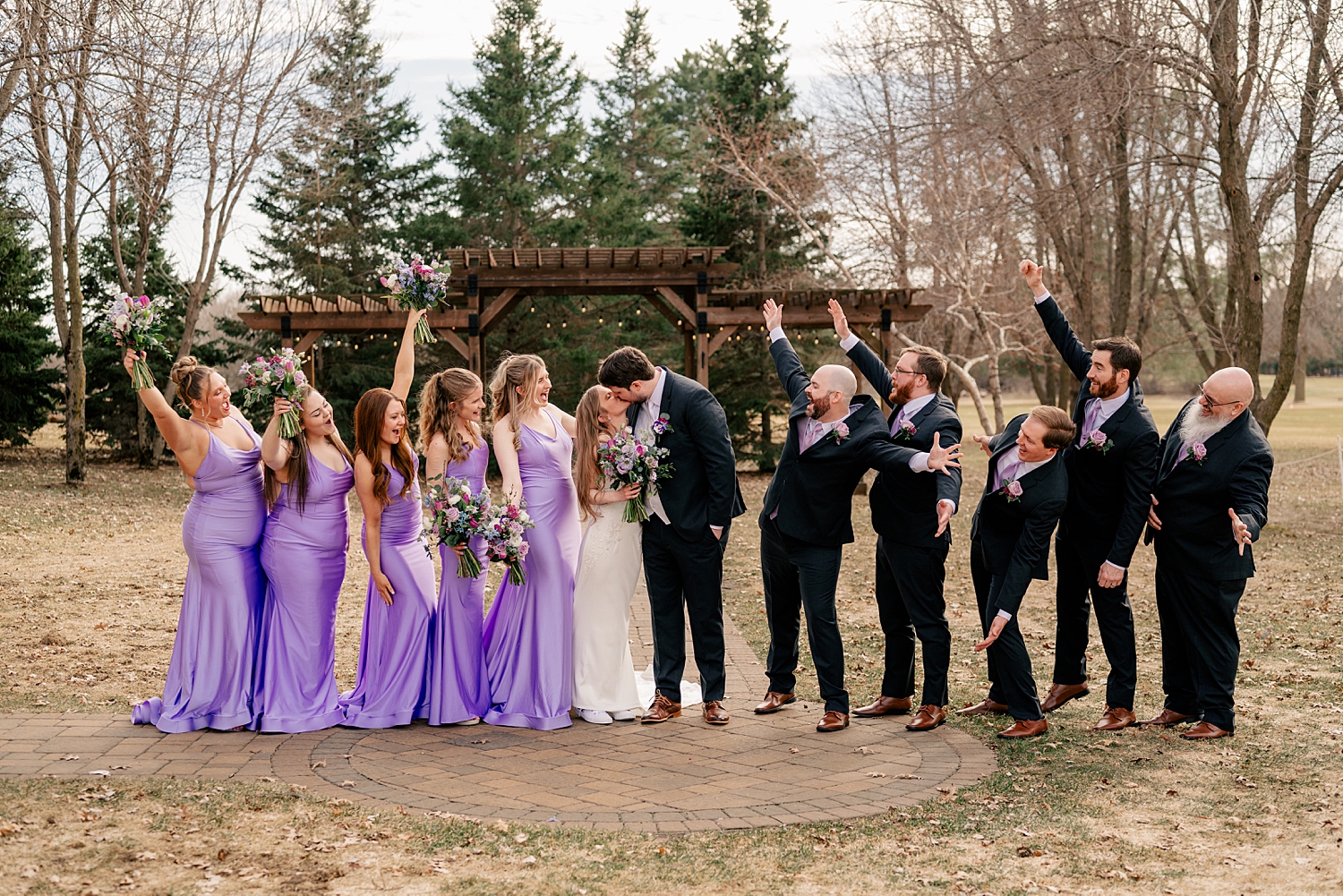 bride and groom surrounded by bridal party in purple & black for Minnesota Spring Wedding