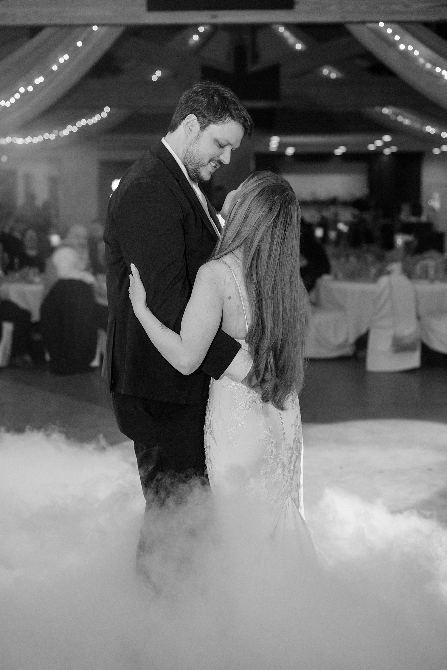 newlyweds share a dance on reception floor with fog by MN Elopement Photographer