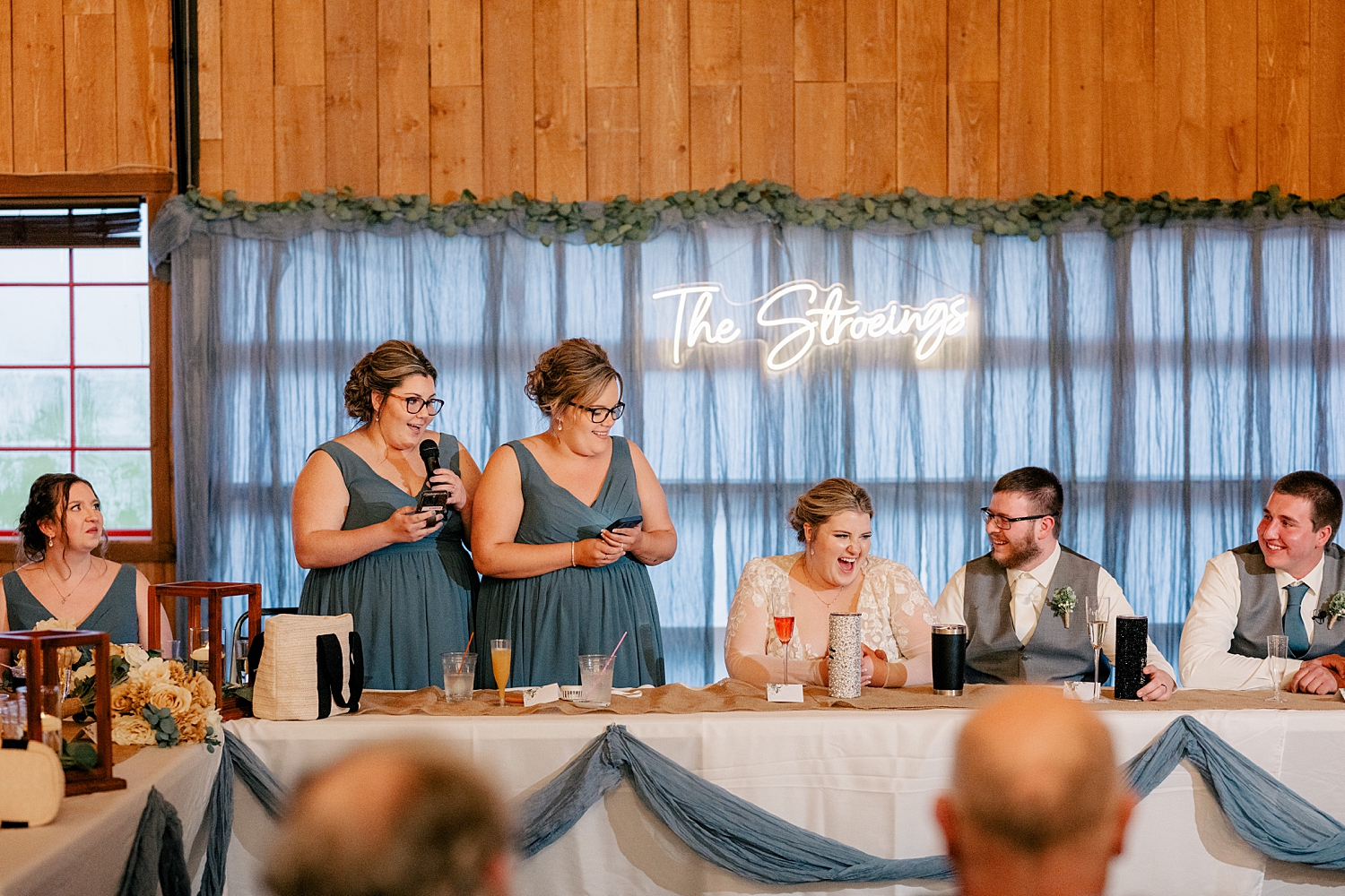 newlyweds laugh during toasts by MN elopement photographer