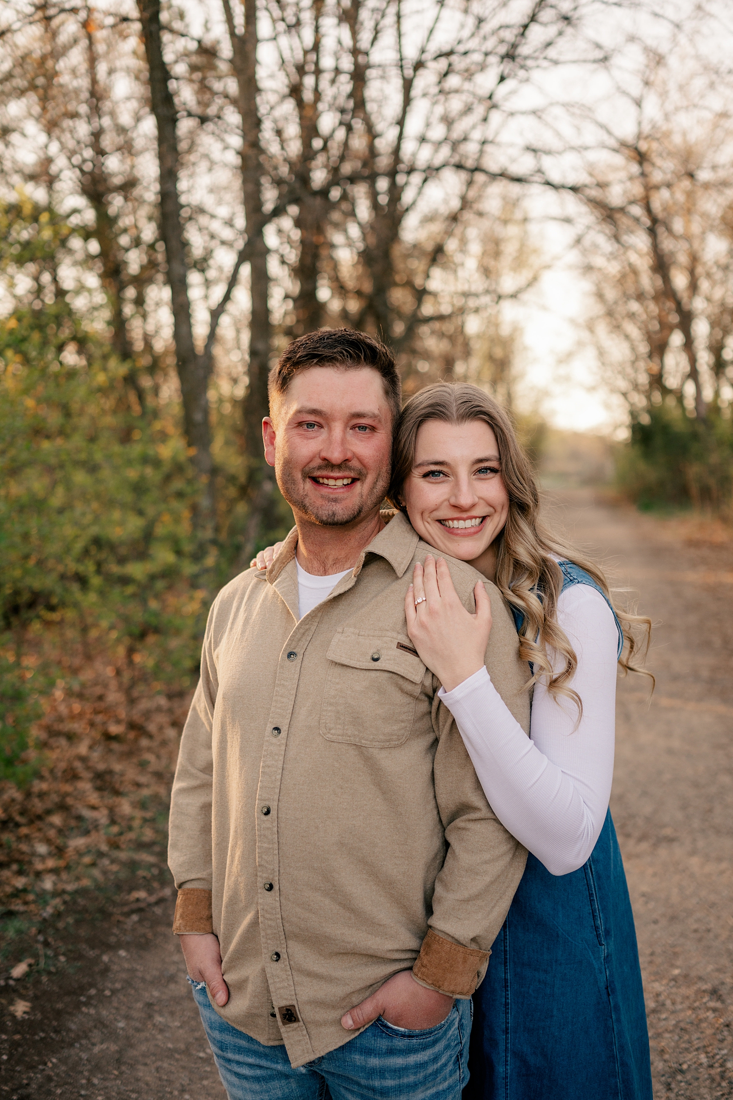 blonde bride to be hugs her fiacne outdoors by Rule Creative Co