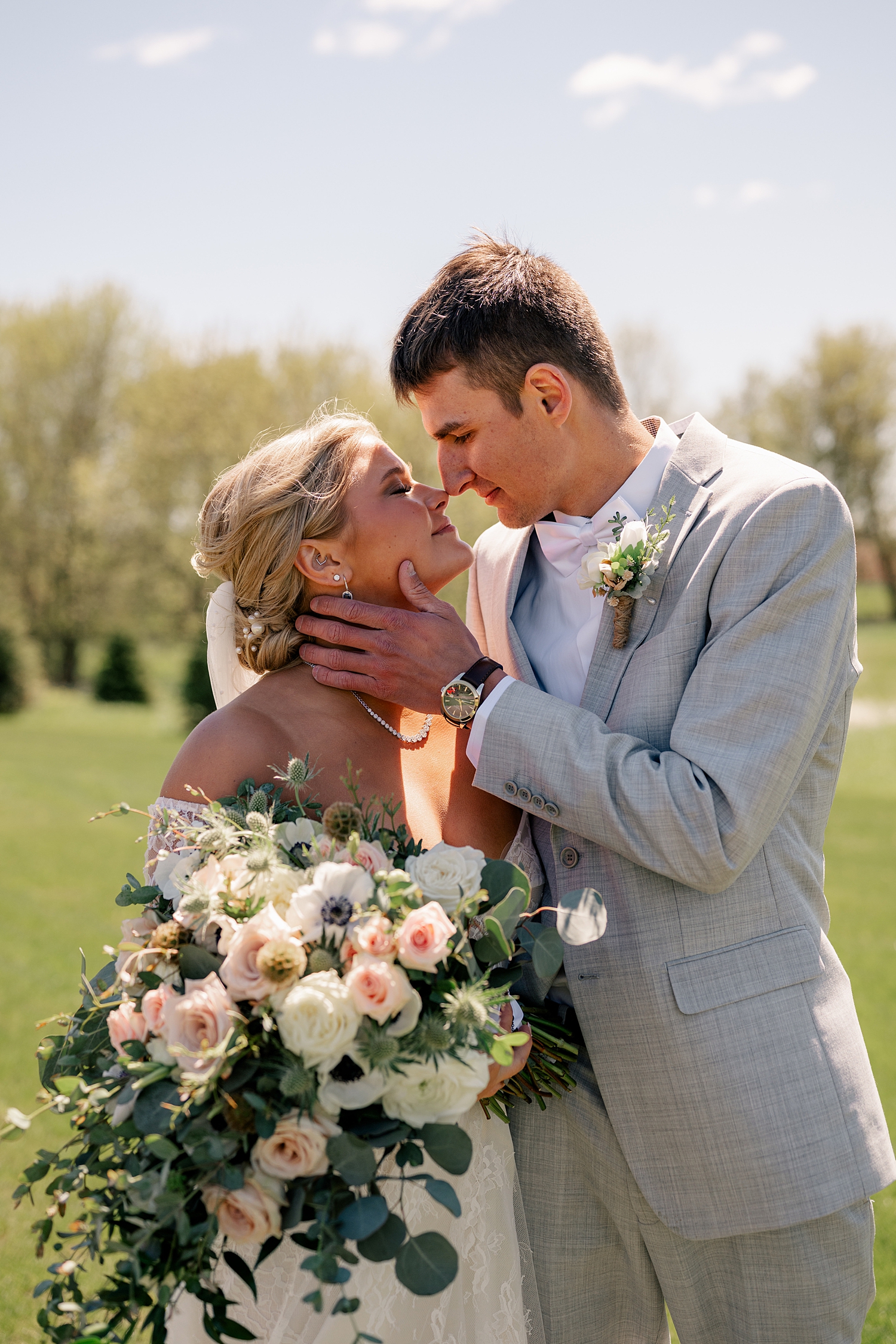 couple embrace in open field by Rule Creative Co 