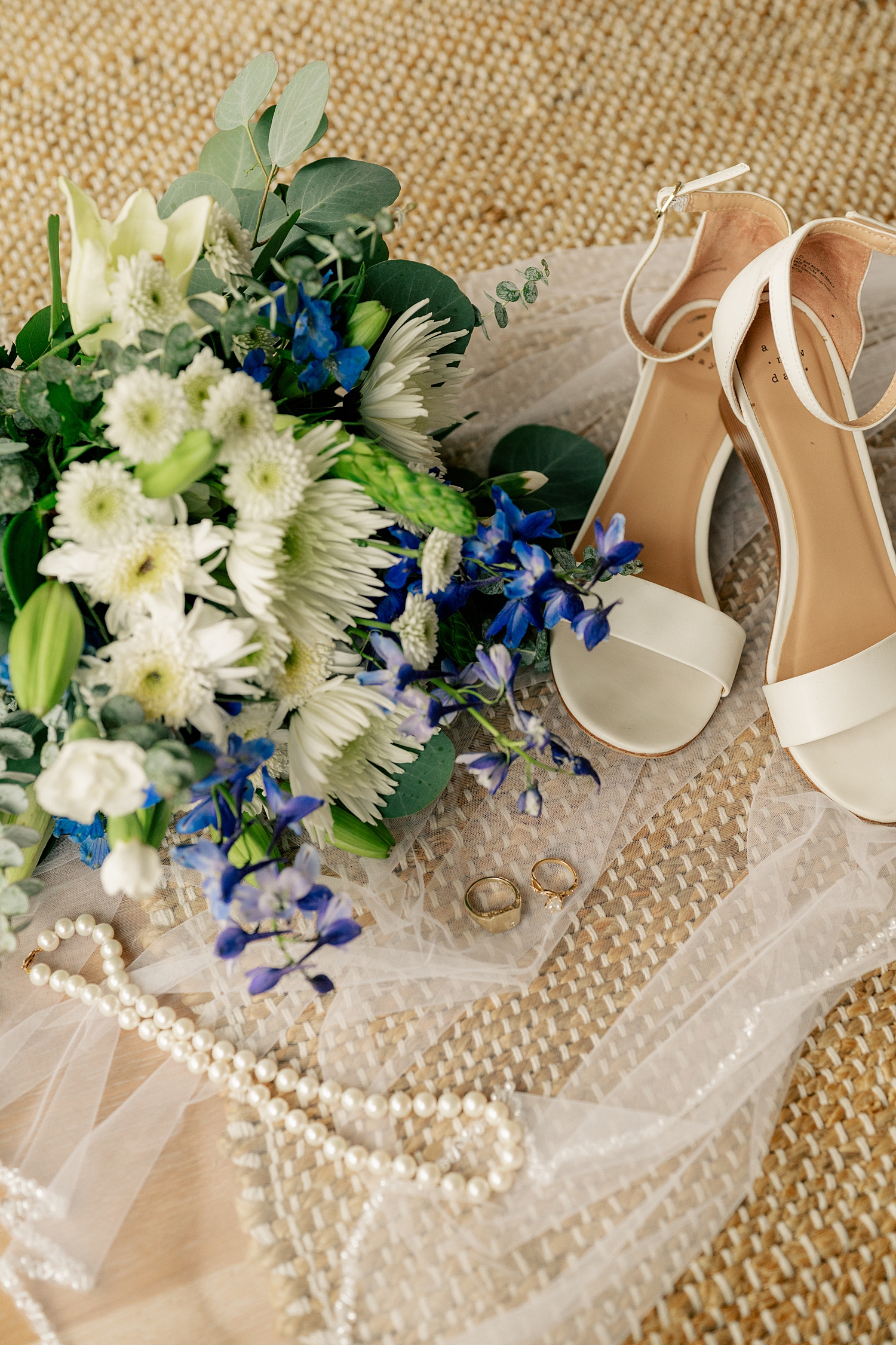 jewelry, shoes and flowers on the ground by Rule Creative Co