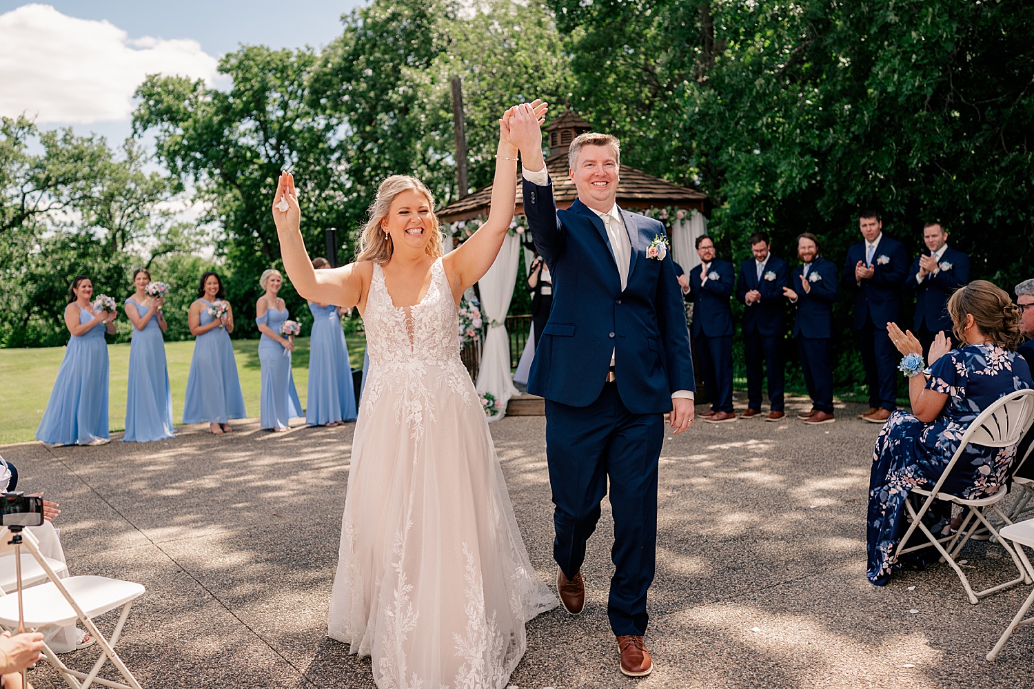 newlyweds exit their outdoor ceremony by Minnesota wedding photographer 
