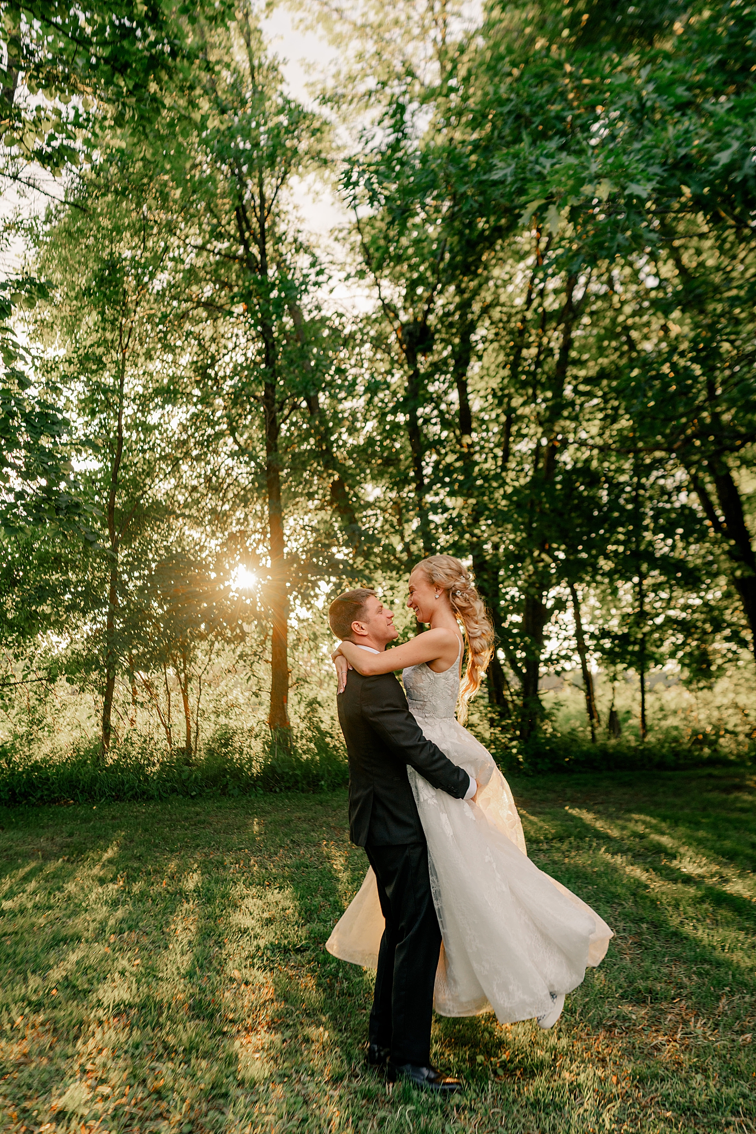 newlyweds spin in the golden hour lighting at Abella Weddings and Events