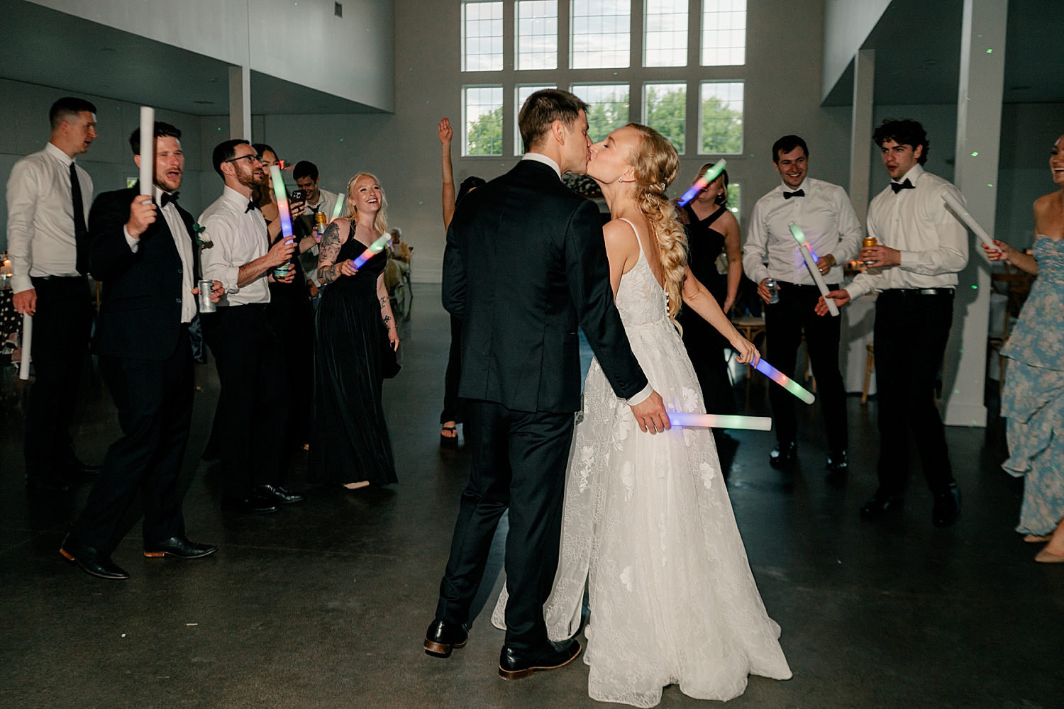 husband and wife share a kiss on reception dance floor at Abella Weddings and Events