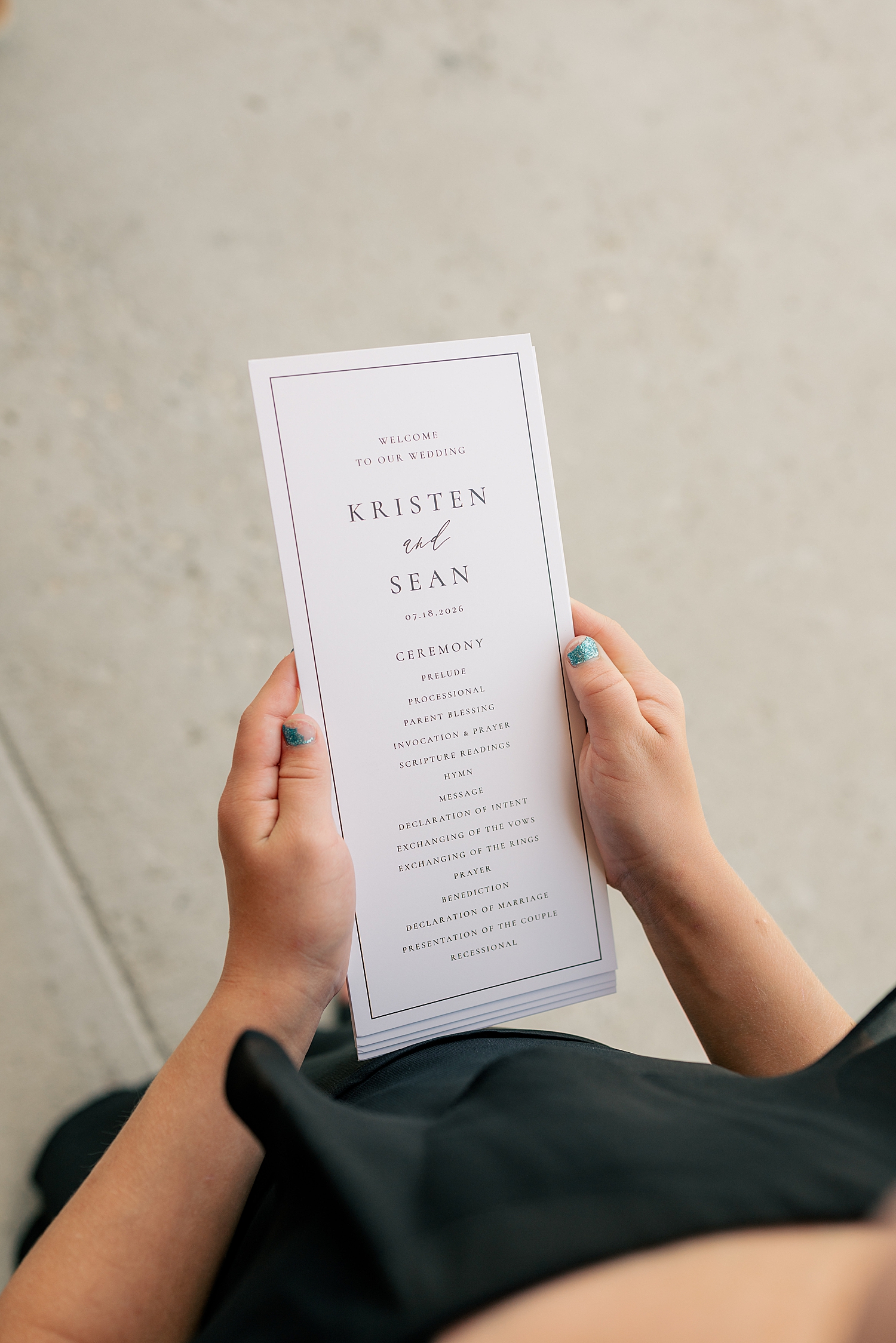 child holds ceremony pamphlet by Rule Creative Co