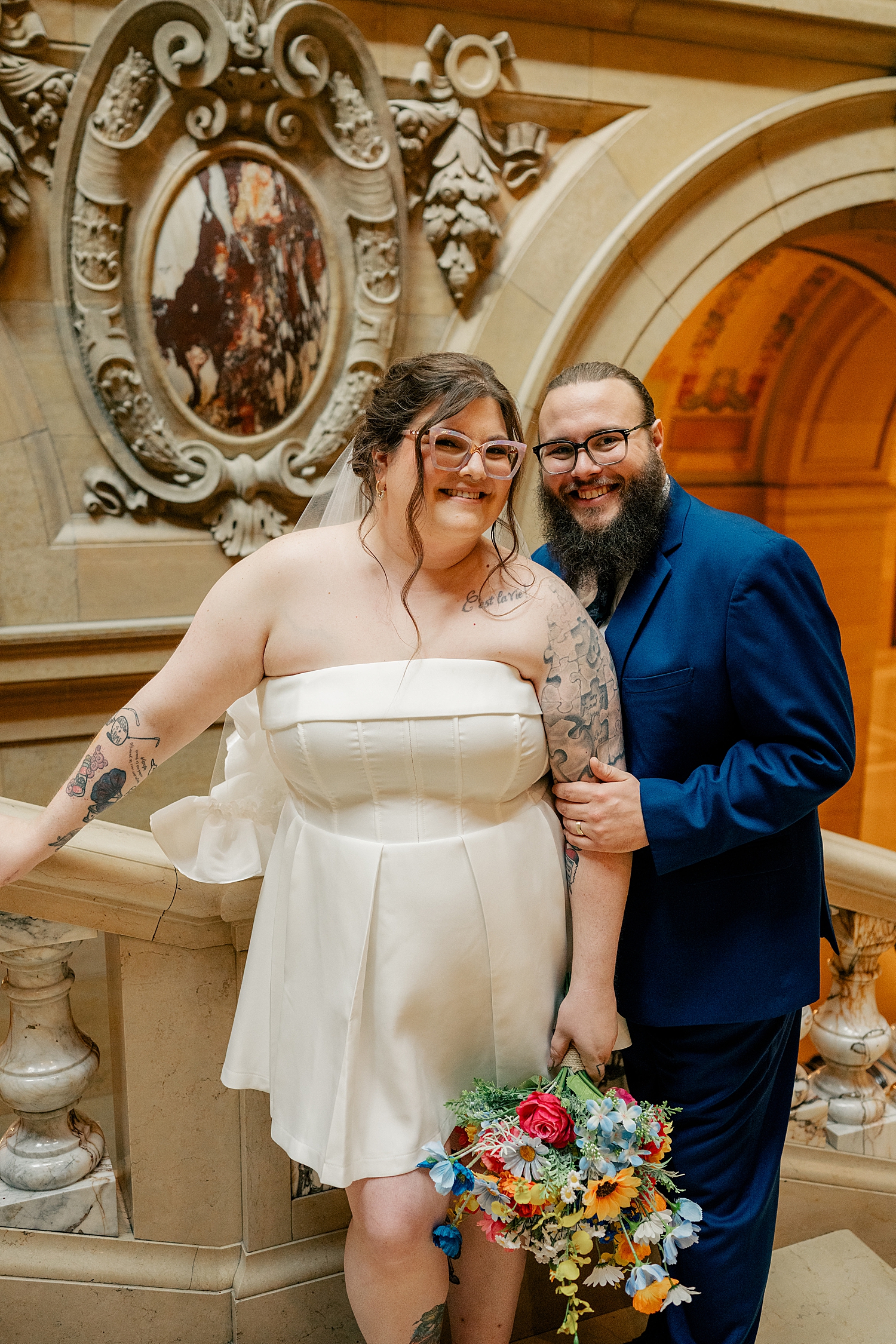 man and woman stand on staircase in official building by Rule Creative Co