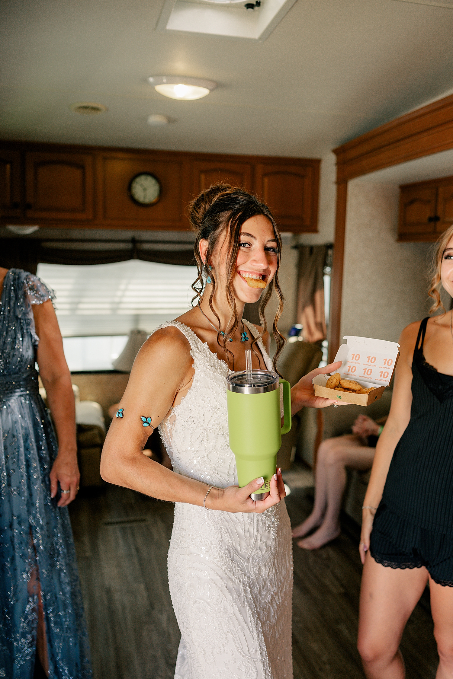 bride eats chicken tenders in RV with friends by Rule Creative Co