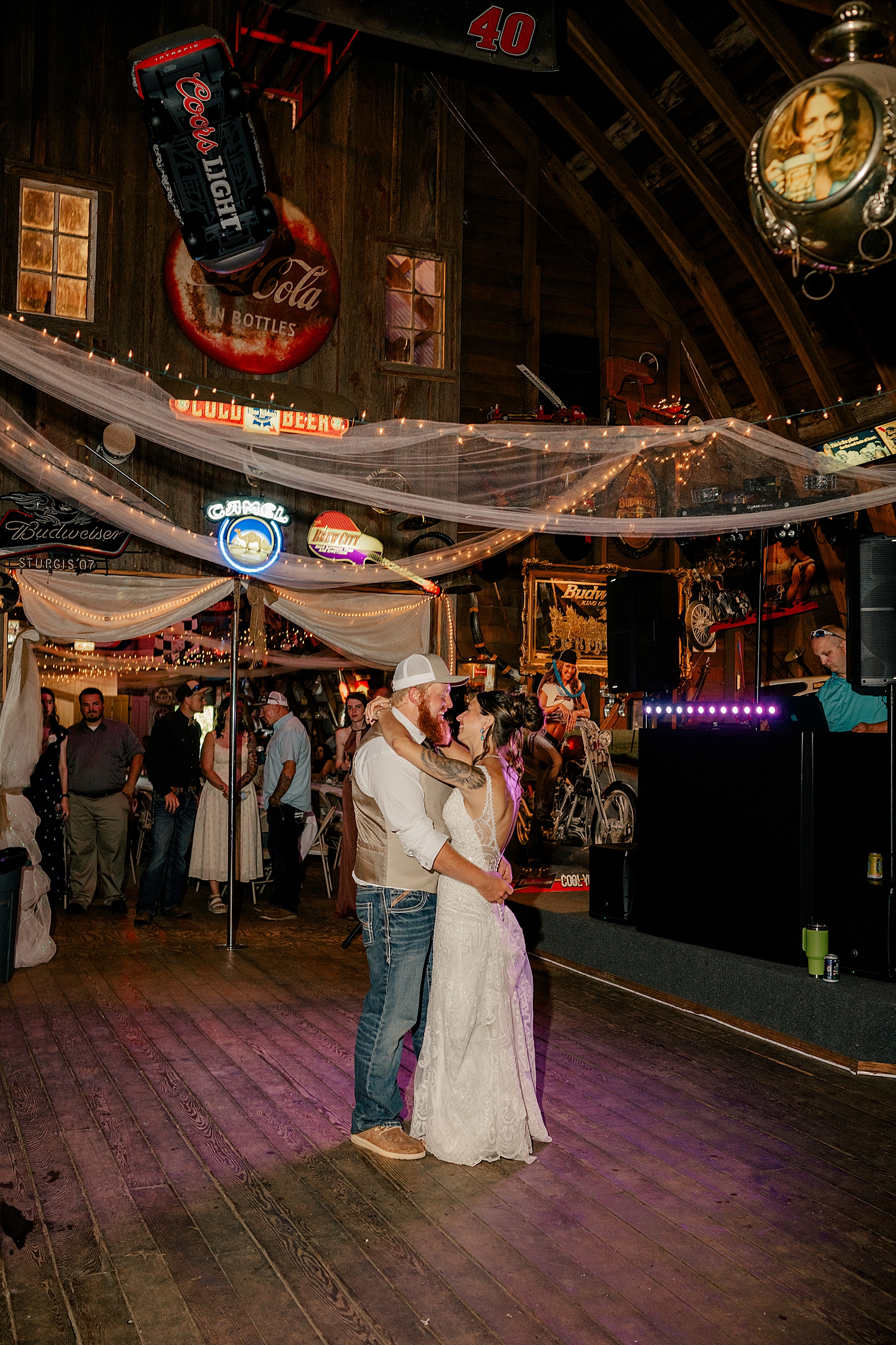 newly married couple share a first dance in rustic barn by Rule Creative Co