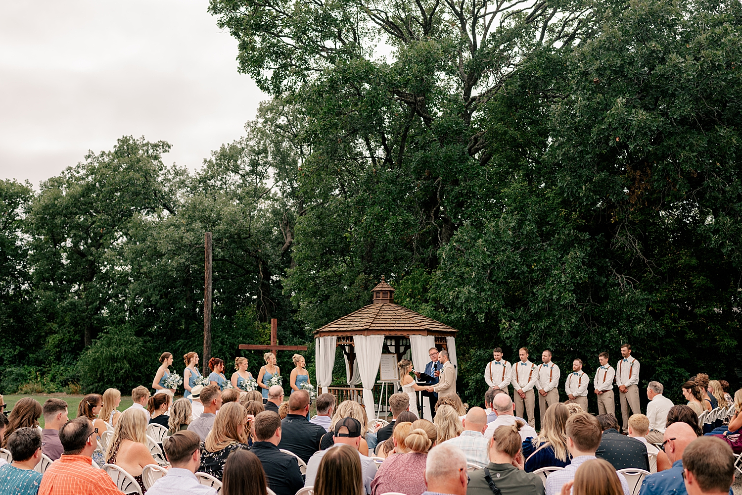 couple exchange vows at outdoor alter for a family-friendly wedding